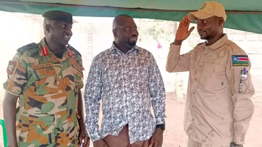 Badur Emmanuel Dominic Dismo salutes SSPDF officers after defecting from SPLM-IO in Western Equatoria State.